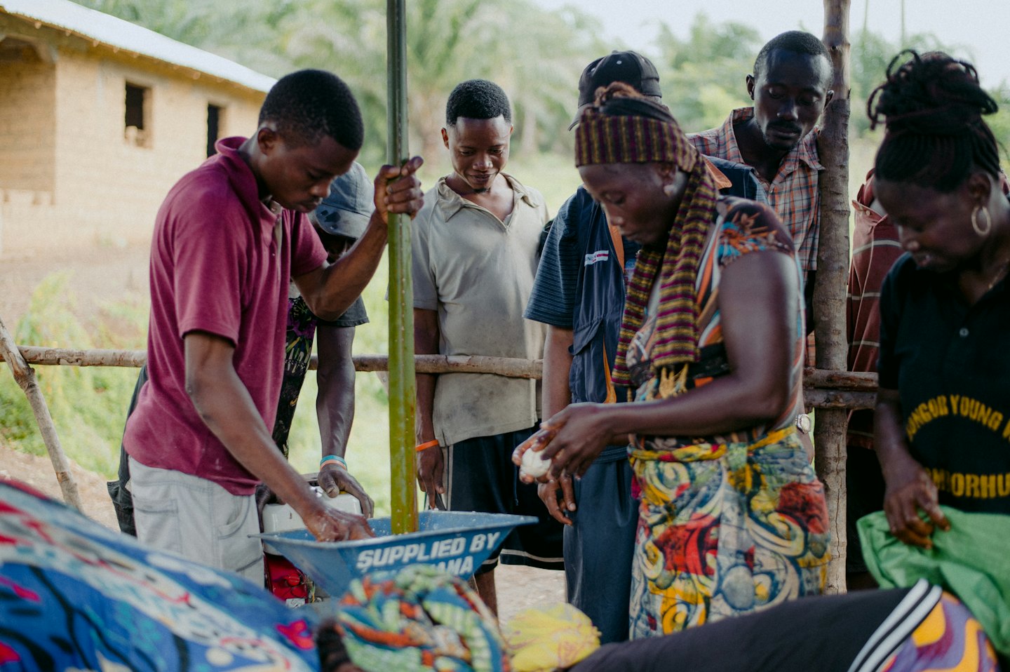 A group of people working together in a rural outdoor setting.